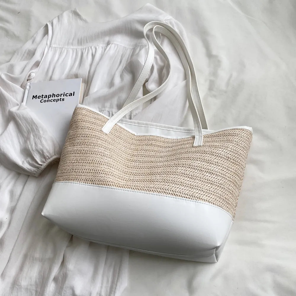 Women’s summer straw tote bag with leather shoulder strap.